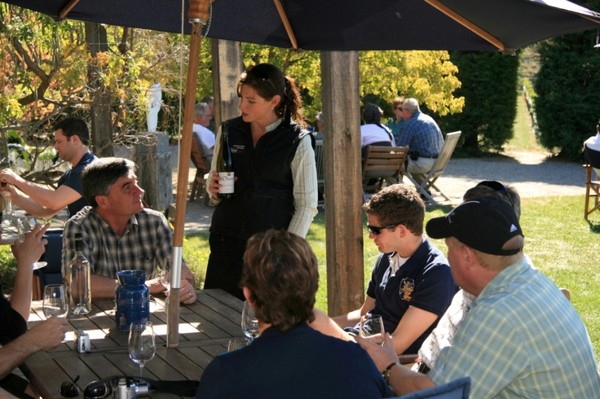 Appellation Central guide Kirsty Hart serves wine at Olssens Winery in Bannockburn
